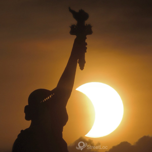 solar eclipse as the sun rose behind the Statue of Liberty