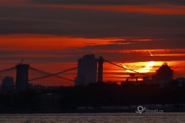 solar eclipse as the sun rose behind the Brooklyn Bridge